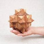 Casse-tête Antivirus L en bois tenu dans une main.