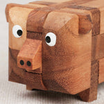 Casse-tête énigme Le Cochon en bois – détail de la tête avec yeux et groin