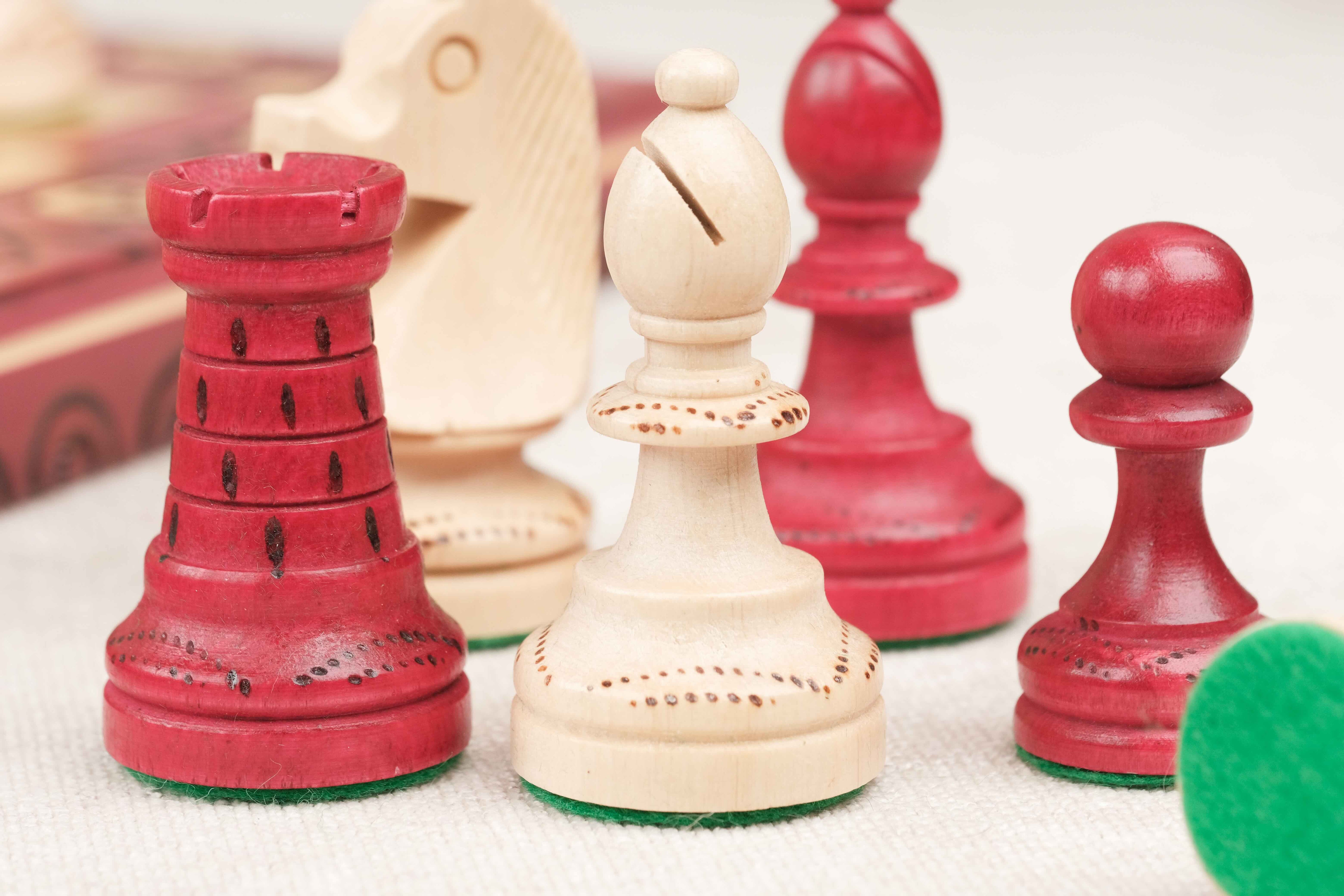 Zoom des pièces d’échecs rouge et beige sculptées en bois