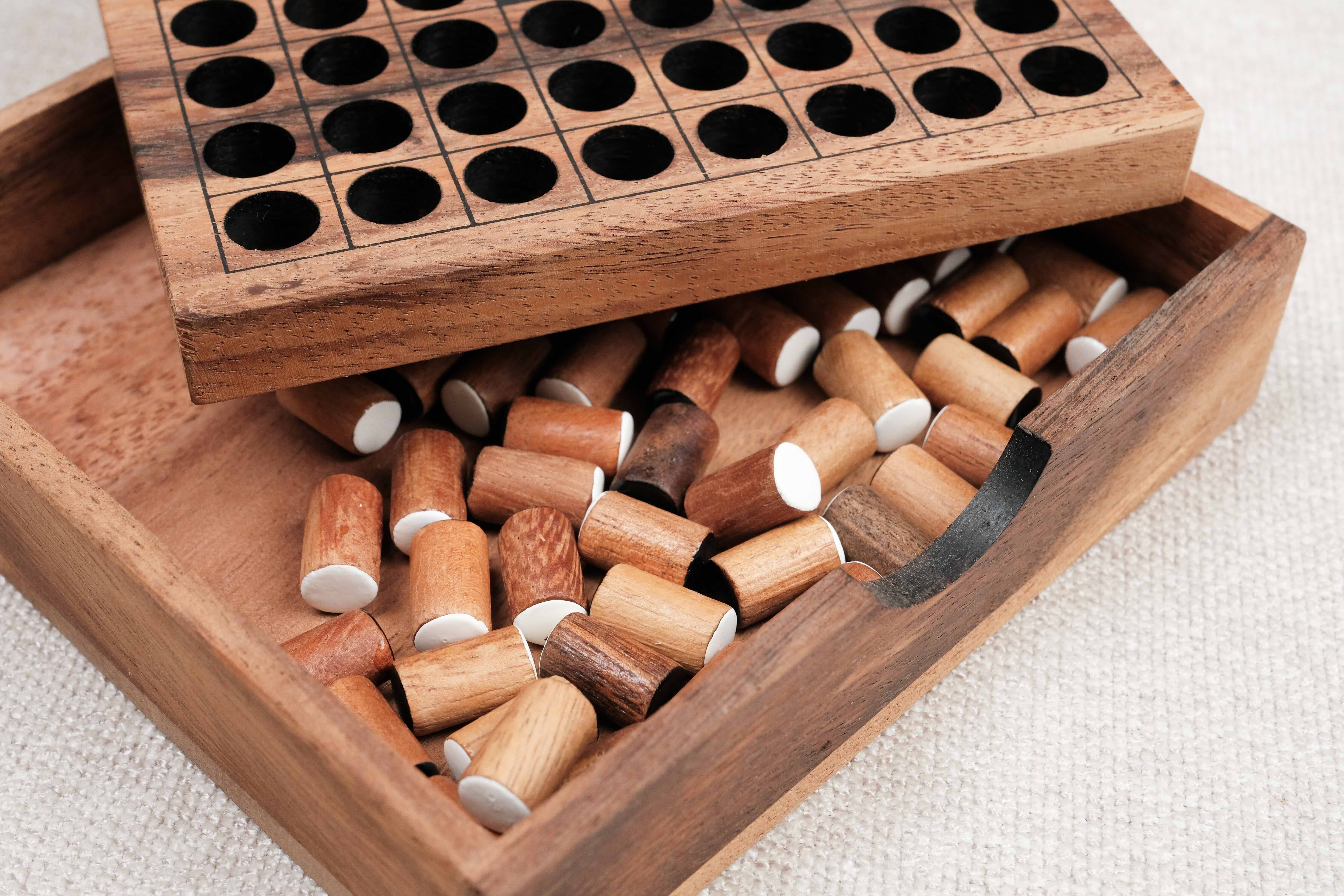 Coffret ouvert contenant le plateau et les pions du jeu Othello en bois