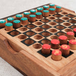 Plateau d’échecs de voyage en bois avec pions rouges et bleus