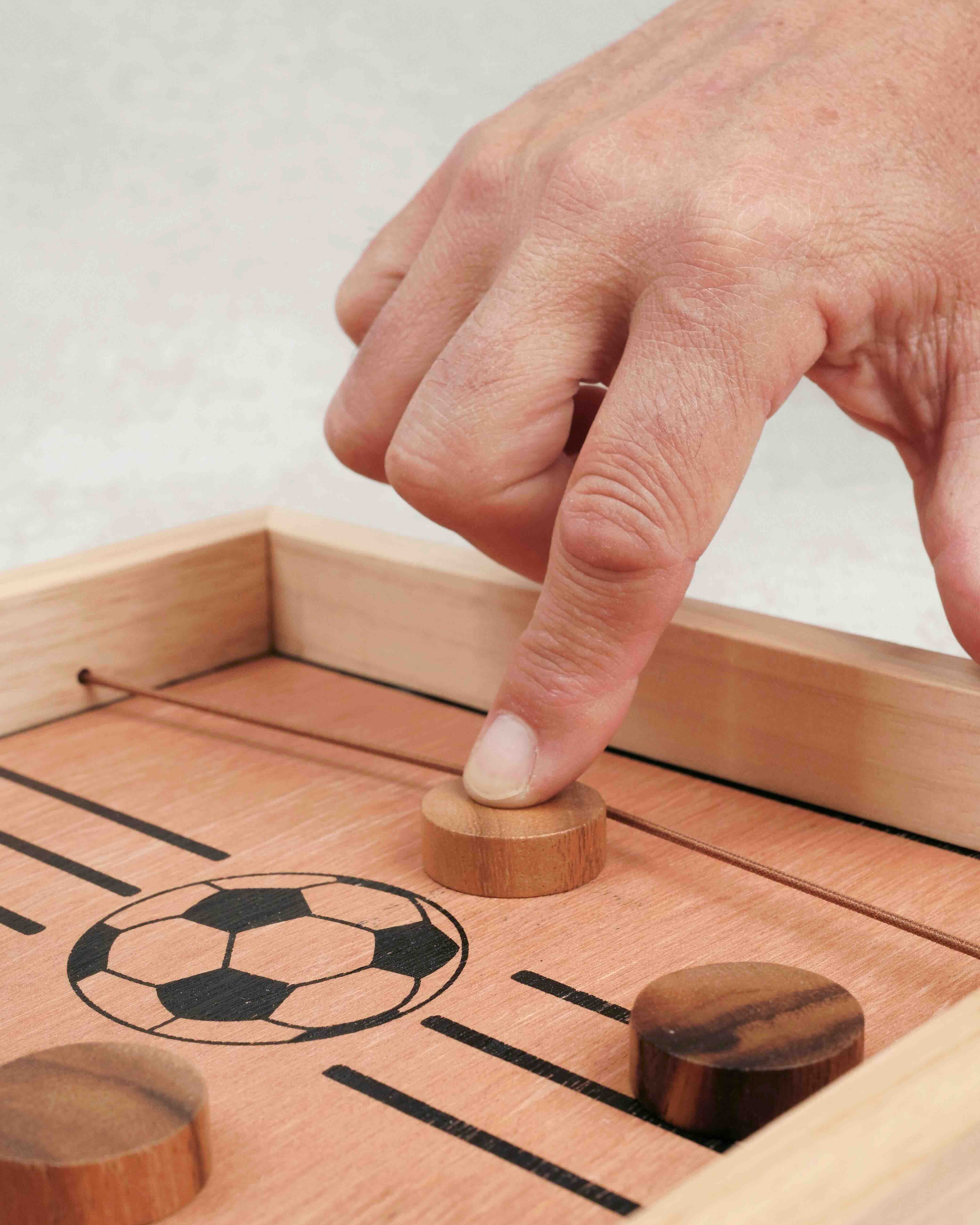 Main propulsant un palet avec l’élastique sur la Table à élastique