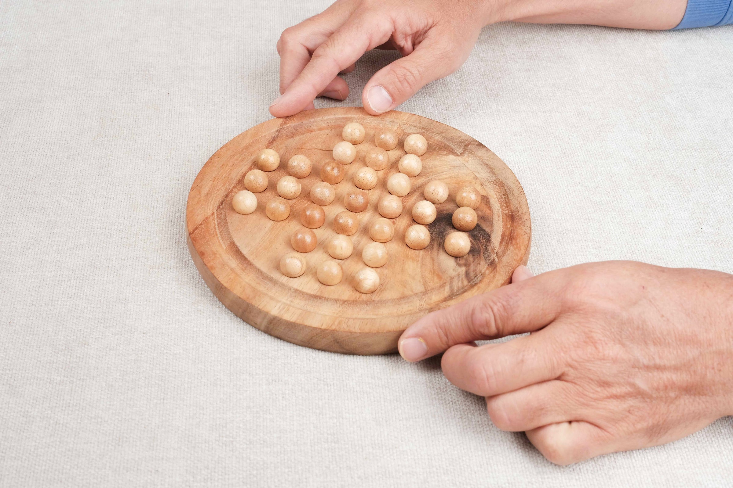 Partie en cours du Solitaire rond format M en bois, pions clairs et foncés – Jeux Faugère