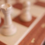 Vidéo Jeux Faugère : dézoom sur le jeu d'échecs en marqueterie XL posé sur une table dans un salon, ambiance cosy